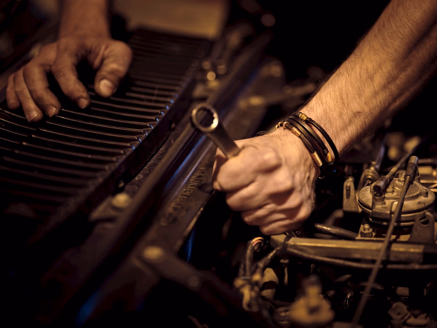 Hands torquing a fastener on an engine
